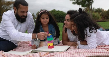 Poster - Indian parents having fun at city park doing picnic while playing with their children - Family, summer and love concept 