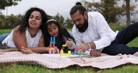 Wall Mural - indian parents having fun at city park doing picnic while playing with their children - family, summ