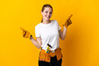 © luismolinero - Young electrician woman isolated on yellow background pointing finger to the laterals and happy