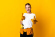 © luismolinero - Young electrician woman isolated on yellow background pointing to the front and smiling