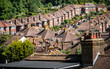 Suburban Rooftops. An elevated view over a post-war 1950's suburban housing estate on the fringes of Old Town Eastbourne backed by ancient woodland.