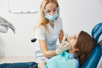 Wall Mural - Careful dentist in safety equipment doing a dental check