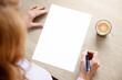 © Kaspars Grinvalds - Woman sitting at desk with pen in hand and looking at blank white sheet of paper