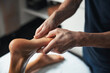 © Viacheslav Yakobchuk - Beautiful charming woman feet in male masseur hands getting manual therapy with essential oil in spa salon