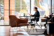 © Monkey Business - Businessman Relaxing Reading Magazine In Lobby Of Modern Open Plan Office