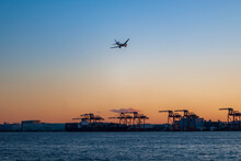 Gantry Crane And Plane In Tokyo Bay At Sunset
