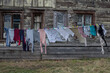 Clean laundry hangs on a clothesline on the street near an old wooden house in Russia. Air drying of laundry