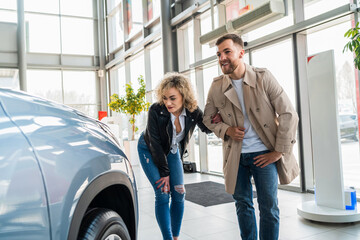 Wall Mural - Beautiful couple in car dealership chooses car