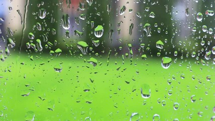 Wall Mural - water droplets flowing on glass
