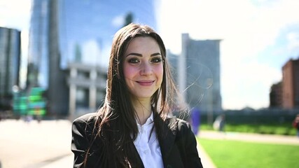 Wall Mural - Beautiful businesswoman smiling in a windy day - slow motion