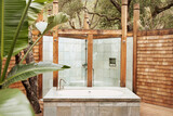 Fototapeta Las - Outdoor bathtub and shower