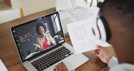 Poster - African american male college student holding notes while having a video call on laptop at home