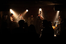 WIDE People Dancing During Concert Of A Modern Jazz Band Playing On A Stage Of A Small Crowded Venue