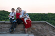 © somemeans - Mother and three children have fun on nature background. Vacation with children.