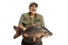 Happy And Exctied Mature Fisherman Holding A Big Carp Fish