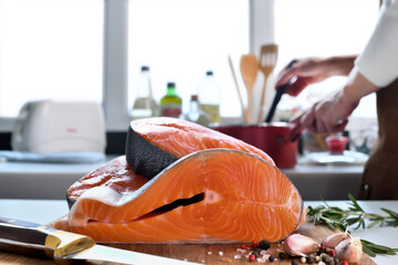 Wall Mural - Fresh raw salmon fillet steaks with ingredient on a cutting board in the kitchen