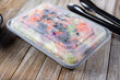 © DAVID - A view of a garden salad enclosed inside a plastic to-go box.