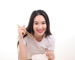 Wall Mural - Beautiful young south east Asian woman holding chinese empty chopstick soup spoon bowl utensil pretend acting posing see eat taste feed offer satisfaction yummy white background happy