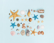 Summer Flat Lay With Colorful Sea Stars, Seashells, Pebble Stones On Blue Background.