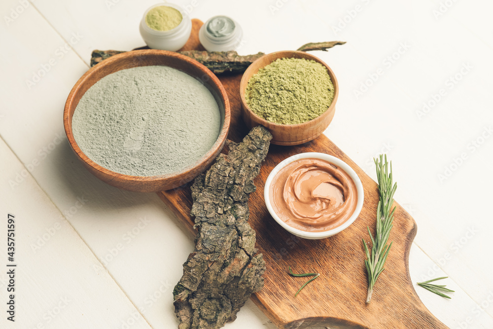 Composition with cosmetic clay on light wooden background