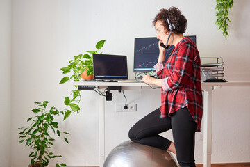 Woman telecommuting at an adjustable standing desk