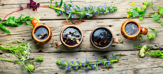 Wall Mural - Mugs of herbal tea with various herbs