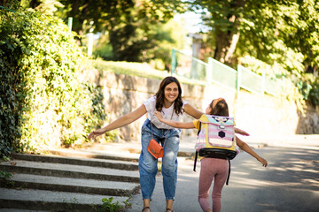 Wall Mural - Mother and daughter having fun outside.