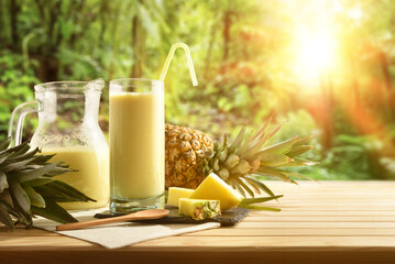 Wall Mural - Glasses with pineapple juice with milk and tropical nature background