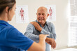 © Rido - Physiotherapist working with senior patient in clinic