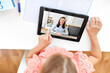 © Syda Productions - online education, e-learning and technology concept - happy student girl with teacher on tablet computer screen having video class at home
