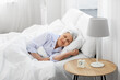 © Syda Productions - old age and people concept - senior woman sleeping in bed at home bedroom