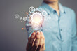 © Aon Khanisorn - Idea concept with innovative technology, Brainstorming creativity, idea thinking with Young Asian Businessman holding light bulbs symbol.