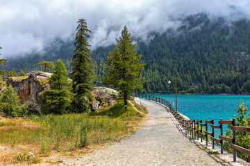 Sticker - Narrow pathway along Lago di Ceresole in Italy.