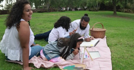 Poster - Indian parents having fun at city park painting with their children - Family, summer and love concept 