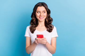 Sticker - Photo of pretty adorable young lady dressed white outfit writing modern gadget looking empty space isolated blue color background