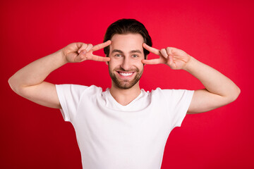 Sticker - Photo of impressed youth brown hairdo man show v-sign wear white t-shirt isolated on vivid red color background