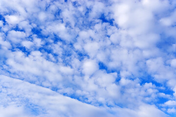 Wall Mural - Blue sky with white clouds background with copy space for text, sky wallpaper.