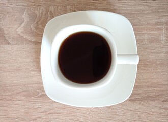 A white cup of coffee on a saucer. Flatley. Breakfast. Drink. Espresso