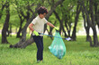 © Daniel CHETRONI - Recycle waste litter rubbish garbage trash junk clean training. Nature cleaning, volunteer ecology green concept. Young men and boys pick up spring forest at sunset. Environment plastic pollution