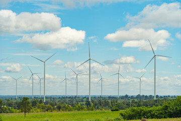 Wind turbines or windmills farm field in industry factory. Power, sustainable green clean energy, and environment concept. Nature innovation.