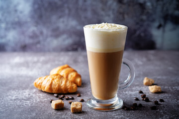 Wall Mural - Coffee with whipped cream in a glass with coffee beans