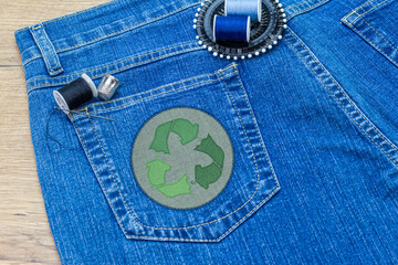 recycle clothes icon patch on jeans, sustainable fashion visible mending concept, repair, recycle, r
