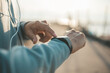 © Charnchai saeheng - sport man checking at smartwatch during training and running in the park.