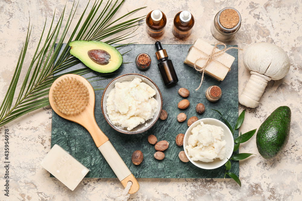 Spa set with shea butter and nuts on grunge background