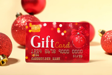 Gift card and Christmas decor on color background