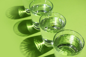 Glasses of water on color background, closeup