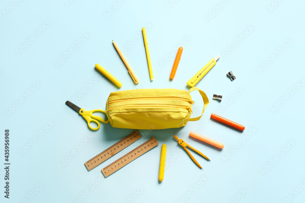 Pencil case and stationery on color background