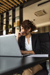 © bnenin - Portrait of a happy businesswoman at office desk.