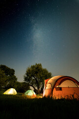 Canvas Print - Starry night and tents on a green field