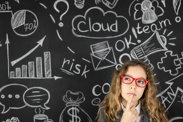 Wall Mural - Young businesswoman against chalkboard with business sketch